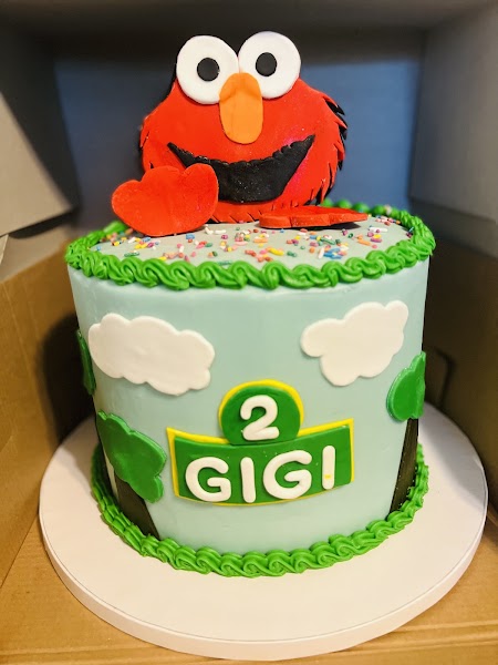 Sesame Street Elmo birthday cake for Gigi's 2nd birthday with sculpted characters, blue buttercream, and rainbow sprinkles