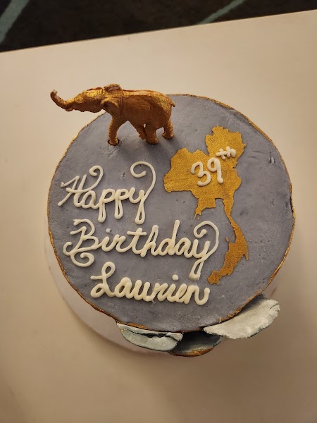 Thailand-themed 39th birthday cake with gold elephant topper and map of Thailand