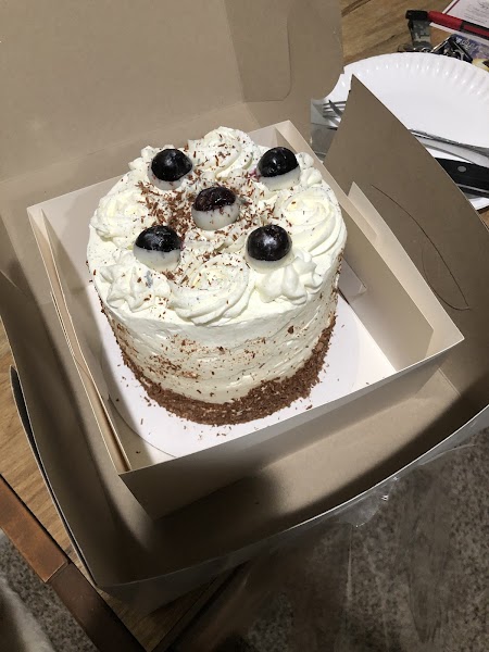 Classic Black Forest cake with whipped cream, chocolate shavings, and cherries
