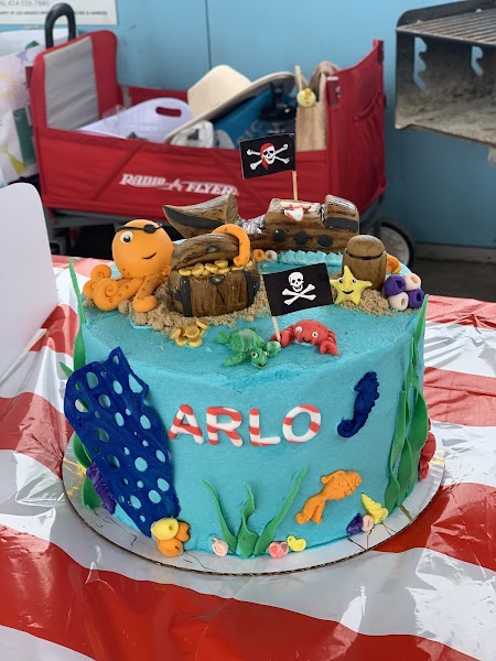 Ocean pirate themed birthday cake in turquoise with fondant sea creatures and treasure chest